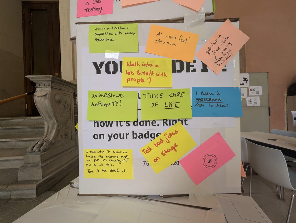 A panel of the tower covered with colorful sticky notes, including “UNDERSTAND AMBIGUITY!”, “TAKE CARE OF LIFE” and “Tell bad jokes on stage”.