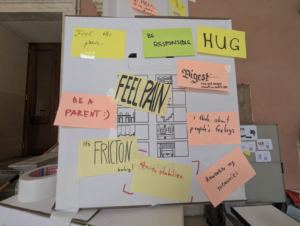 A panel with sticky notes reading “Feel the pain”, “BE RESPONSIBLE”, “HUG”, “FEEL PAIN”, “BE A PARENT :)” and “It's FRICTION baby!”.